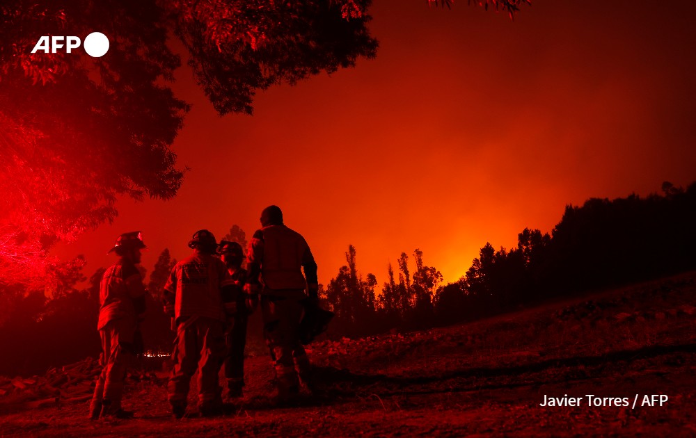 Firefighters during a fire in Puren, Chile.